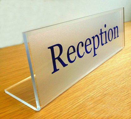 desk sign with blue text