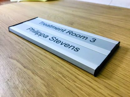 Twin interchangeable sliding door signs