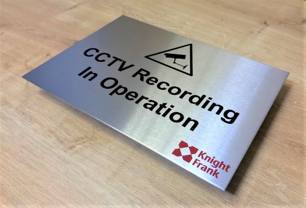 knight-frank-brushed-stainless-steel-engraved-etched-cctv-in-operation-sign-with-black-lettering-red-company-logo