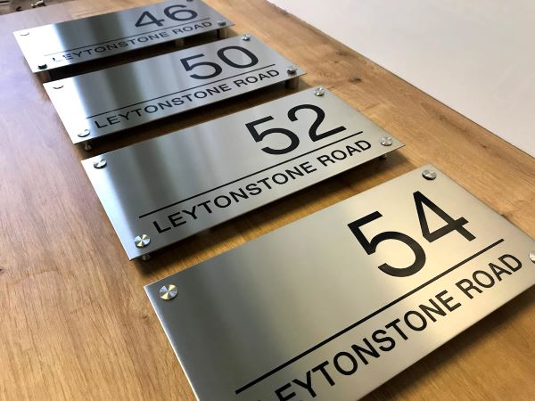 leytonstone-road-london-exterior-brushed-stainless-steel-etched-signs-with-black-lettering-and-standoff-fixings